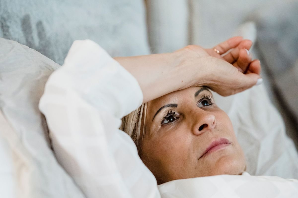 A woman lying awake in bed at night