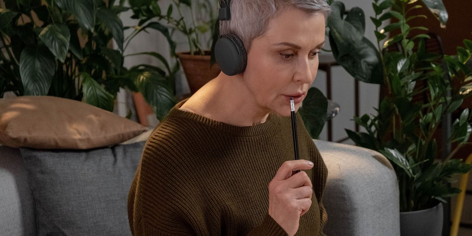 A woman in her fifties sitting at home, working through notes in a journal