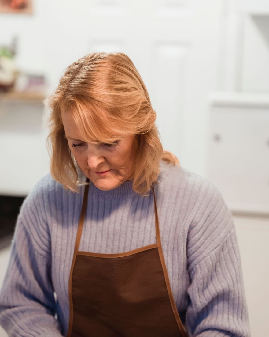 A woman preparing a meal at a kitchen counter